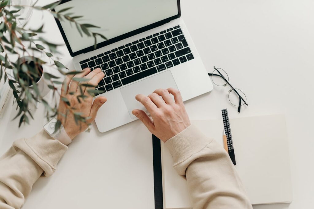 pexels-photo-4065876 An overhead view of a person working on a laptop in a minimalist home office setting.